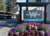 Thumbnail 35 of 35 - A sign for Woodbrook is displayed in front of a building.