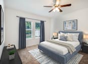 Thumbnail 60 of 63 - A bedroom with a bed, nightstands, and a ceiling fan.