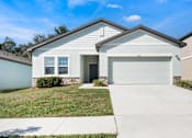 Thumbnail 10 of 63 - A house with a garage door that says 310 on it.