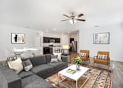 Thumbnail 57 of 63 - A living room with a grey couch and a white coffee table.