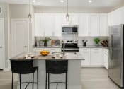 Thumbnail 17 of 39 - Luna at Lake Shadow apartments in Maitland Florida photo of kitchen with custom light fixtures