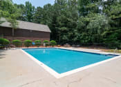 Thumbnail 10 of 24 - Flats at Riverview apartments in Duluth Georgia photo of a swimming pool with a building in the background