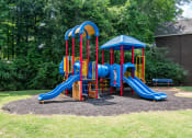 Thumbnail 18 of 24 - a colorful playground with slides and a picnic table