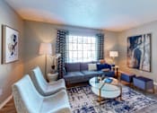 Thumbnail 5 of 16 - Living room at Broad on the Green in Augusta, GA, featuring a large window with natural light in a pet-friendly apartment community.