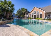 Thumbnail 13 of 20 - Affordable Houston Apartments – Gramercy Park – a large swimming pool in front of our clubhouse