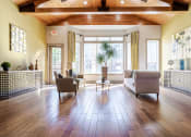 Thumbnail 19 of 20 - Affordable Houston Apartments – Gramercy Park – inside our clubhouse with seating area in front of massive windows