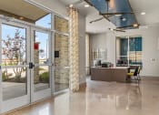 Thumbnail 23 of 43 - a view of the lobby with a reception desk and glass doors