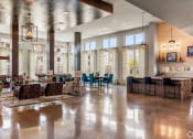 Thumbnail 25 of 43 - a large lobby filled with furniture and a large window