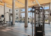 Thumbnail 33 of 43 - a fitness center with cardio machines and weights