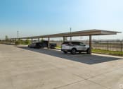 Thumbnail 42 of 43 - a parking lot with cars parked under awning