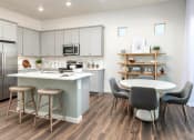 Thumbnail 5 of 16 - an open kitchen and dining area with a table and chairs
