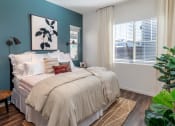 Thumbnail 13 of 16 - a bedroom with blue walls and a bed with white blankets and pillows
