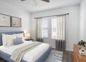Thumbnail 54 of 63 - A bedroom with a bed, nightstand, and a ceiling fan.
