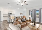 Thumbnail 13 of 63 - A modern living room with a brown leather couch and a white kitchen in the background.