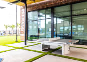 Thumbnail 10 of 40 - a ping pong table in front of a glass door