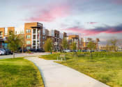 Thumbnail 2 of 40 - a view of a city park with buildings in the background