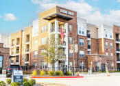 Thumbnail 1 of 40 - a building with a large sign on top of it