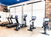 Thumbnail 11 of 40 - a workout room with treadmills and televisions in a fitness center