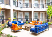 Thumbnail 9 of 40 - a patio with couches and a table outside of a building