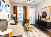 Thumbnail 19 of 40 - a living room with a couch and a television and a painting of a bull