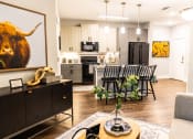 Thumbnail 18 of 40 - a living room with a kitchen and a dining room