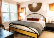 Thumbnail 20 of 40 - a bedroom with a bed and a large window