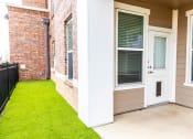 Thumbnail 23 of 40 - the front porch of a brick house with grass