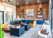 Thumbnail 14 of 40 - a living room with blue furniture and a brick wall