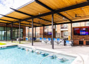 Thumbnail 7 of 40 - the pool is under a covered patio with tables and chairs
