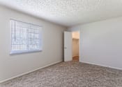 Thumbnail 8 of 17 - Pet-Friendly Apartments in Antioch, TN– Hickory Lake – A room with a carpeted floor and a window with blinds.