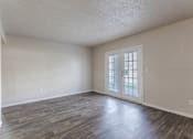 Thumbnail 4 of 17 - Apartments in Antioch, TN 37013 for Rent – Hickory Lake - A room with a sliding glass door and wood flooring.