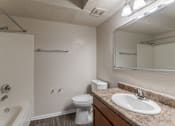Thumbnail 9 of 17 - A bathroom with a sink, toilet, and bathtub.