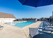 Thumbnail 2 of 17 - Affordable Antioch, TN Apartments – Hickory Lake – A pool surrounded by chairs and umbrellas.