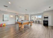 Thumbnail 13 of 19 - Community game room with pool table and open seating at Hinton Heights Apartments in Cottage Grove, MN, a pet-friendly apartment community with spacious shared amenities.