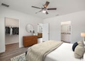 Thumbnail 30 of 35 - A bedroom with a large bed and a ceiling fan.
