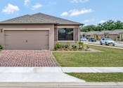 Thumbnail 1 of 35 - A house with a garage door that says "BUILT" on it.