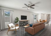 Thumbnail 17 of 35 - A living room with a brown couch, a television, and a ceiling fan.