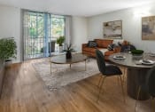 Thumbnail 3 of 23 - Horizons North Apartments near Miami Gardens Florida photo of an open living room and dining room with a large sliding glass door leading to a balcony