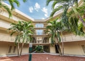 Thumbnail 19 of 23 - Horizons North Apartments near North Miami Beach Florida Photo Of a large building with palm trees in front of it