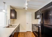 Thumbnail 2 of 19 - Houston Street Manor apartments in Jacksonville, FL photo of Updated kitchen with black appliances