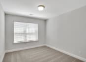 Thumbnail 16 of 26 - Harris Trail Luxury Townhomes for rent Richmond Hill, GA photo of bedroom with large window and plush carpeting