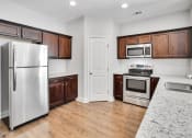 Thumbnail 5 of 26 - Harris Trail Luxury Townhomes for rent Richmond Hill, GA photo of kitchen with pantry and exspresso cabinets