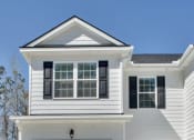 Thumbnail 2 of 26 - Harris Trail Luxury Townhomes for rent Richmond Hill, GA photo of white townhome with garage