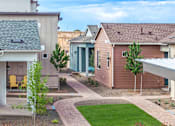 Thumbnail 43 of 47 - A residential area with houses and a clear sky.