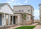 Thumbnail 41 of 47 - A row of houses with a blue sky in the background.