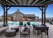Thumbnail 21 of 47 - A modern outdoor living space with a pool and furniture.
