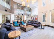Thumbnail 23 of 33 - a living room with couches and chairs and a kitchen