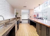 Thumbnail 22 of 33 - a large kitchen with a long counter and a sink