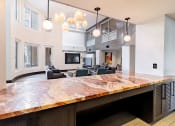 Thumbnail 21 of 33 - a large kitchen with a counter top and a living room
