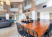 Thumbnail 20 of 33 - a large dining room with a long wooden table and chairs